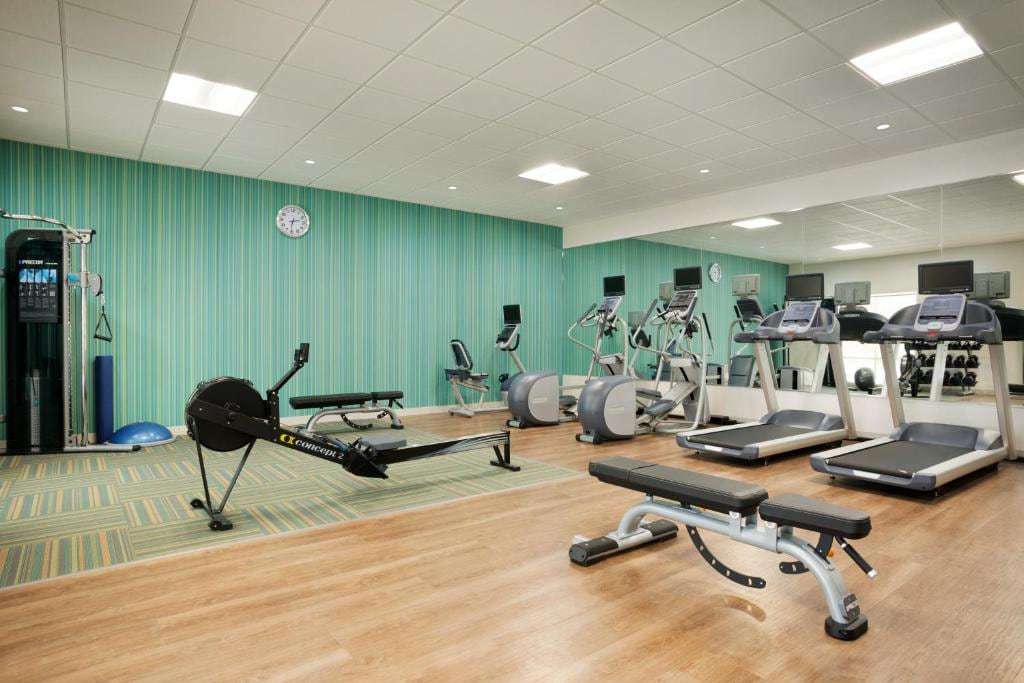 Fitness center with treadmills, ellipticals, rowing machine, weight bench and cable machine
