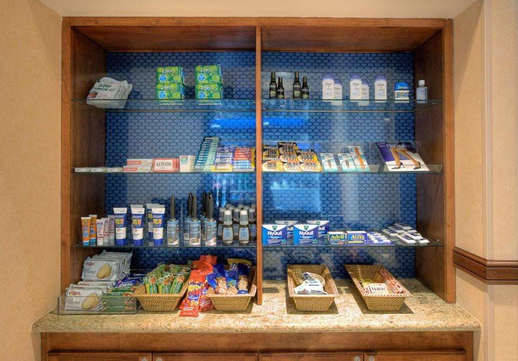 Convenience shop shelves stocked with snacks, toiletries and over-the-counter medicine