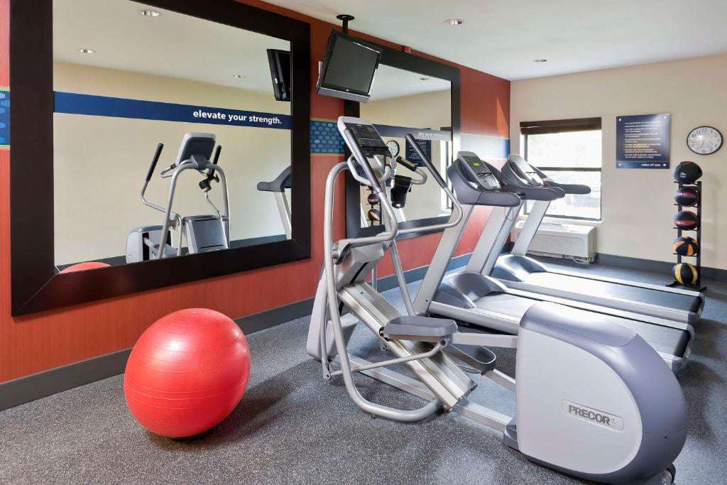 Fitness center with elliptical, two treadmills, exercise ball and medicine ball rack