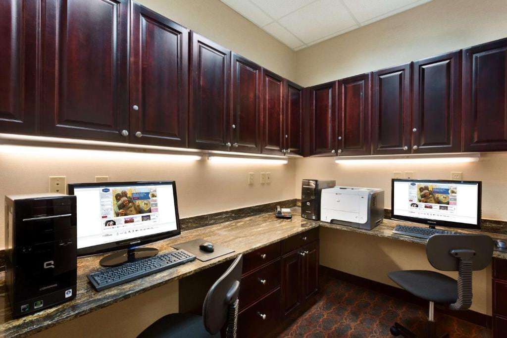 Business center with two computers, a printer and a granite work counter