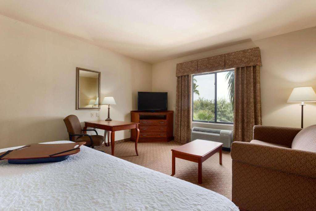 Studio suite with one bed, sofa, coffee table, work desk and corner TV