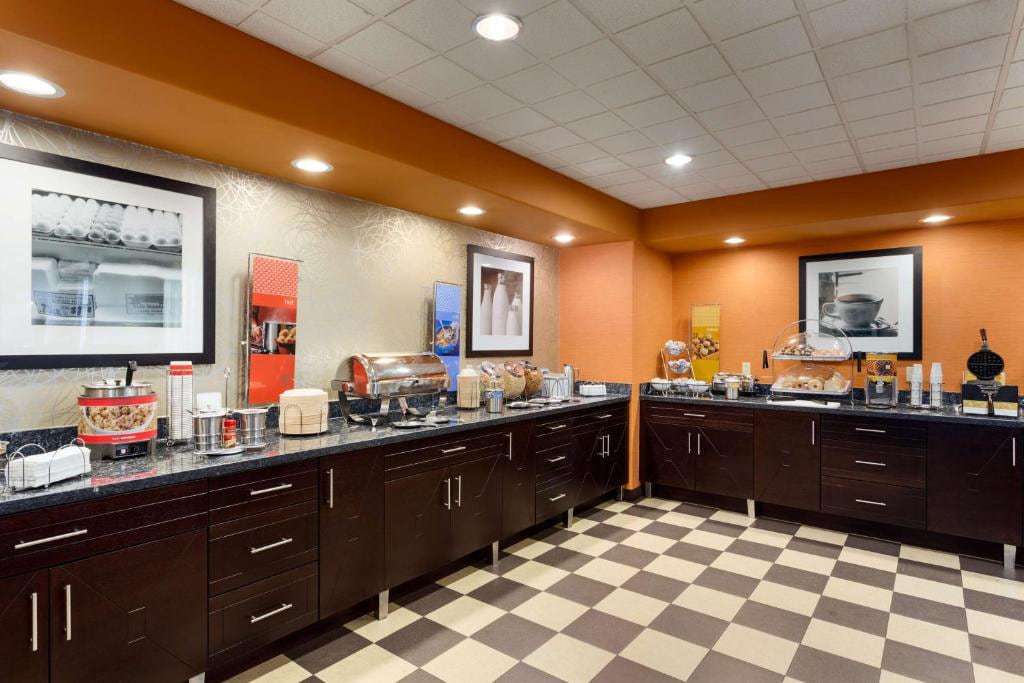 Breakfast buffet with oatmeal, hot food station, pastries and waffle maker