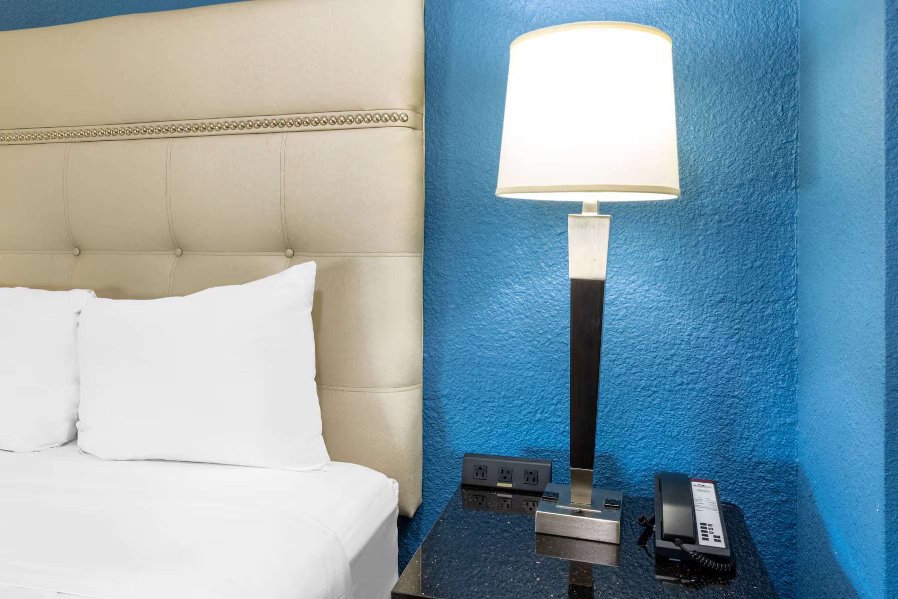 Bedside table with lamp, phone and power outlets