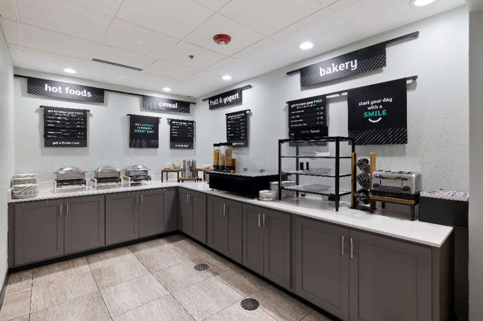 Breakfast buffet with hot foods, cereal, fruit and yogurt, and bakery stations