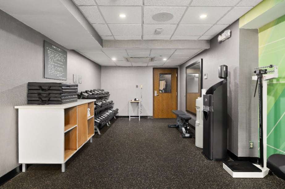 Fitness center with dumbbells, weight bench, water dispenser and scale